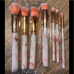 7 make up brushes.  4 large 3 small pink handles